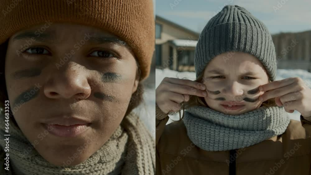 Split screen close-up vertical portrait shot of teenage African American girl and young Caucasian boy in winter hat, scarf and jacket painting war stripes on face before snowball fight in yard