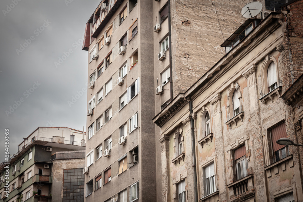 Fototapeta premium Selective blur on old residential buildings with decaying walls in downtown Belgrade, Serbia, needing heavy renovation with damaged peeling plaster.