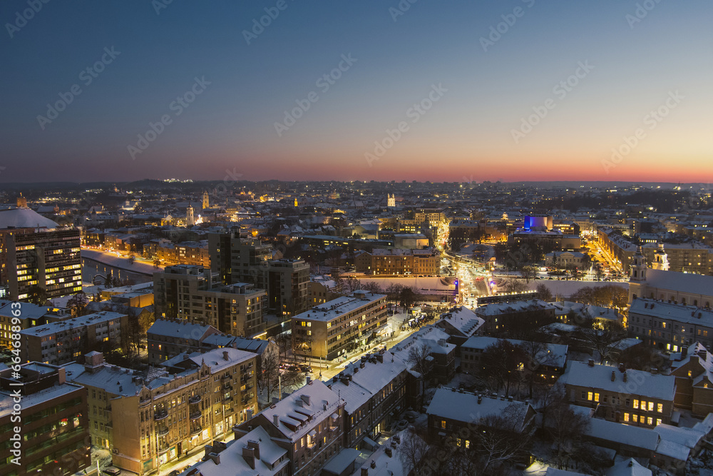 Beautiful aerial evening view of illuminated business district in Vilnius. Winter sunset in capital of Lithuania. Beautiful aerial evening view of illuminated business district in Vilnius. Winter sunset in capital of Lithuania.