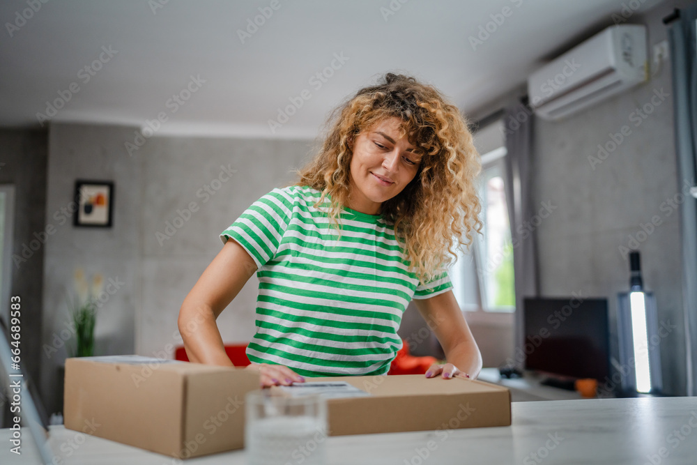 one happy woman open mail cardboard package box present at home one happy woman open mail cardboard package box present at home