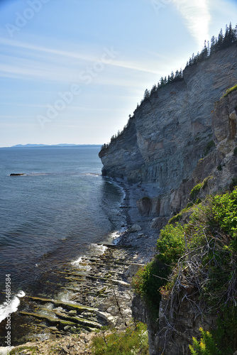 Gaspé Cape land’s end cliff. Seascape of famous hiking trail in Forillon National Canada Park. Gulf of St-Lawrence.