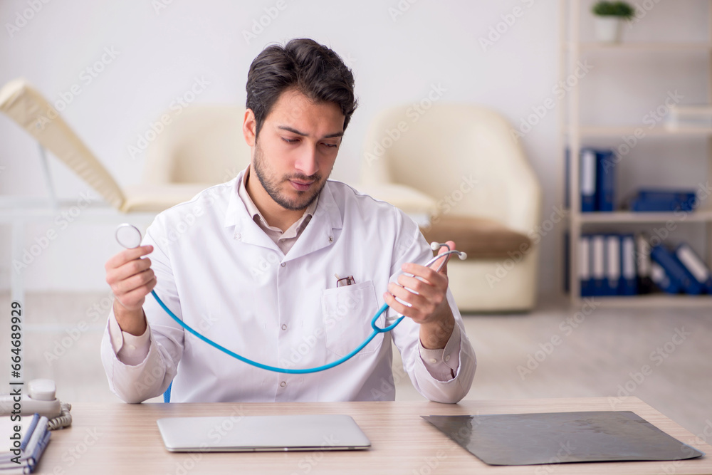 Young male doctor working in the clinic Young male doctor working in the clinic