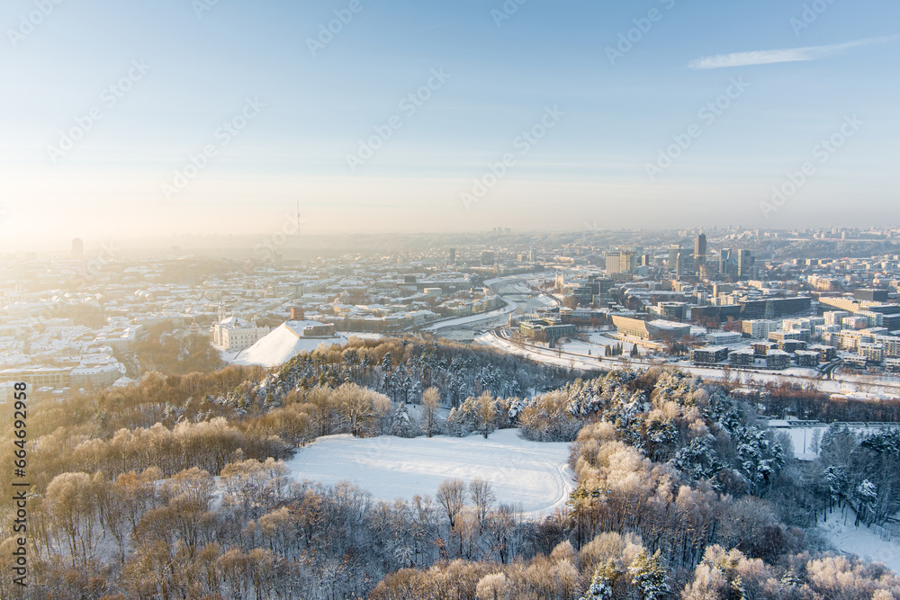 Fototapeta premium Beautiful sunny Vilnius city scene in winter. Aerial early evening view. Winter city scenery in Lithuania.