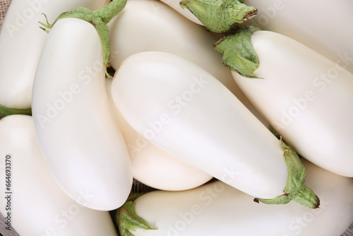 Fresh white eggplants as background, top view