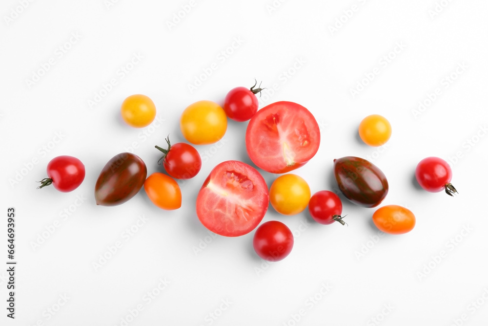 Flat lay composition with different whole and cut tomatoes on white background Flat lay composition with different whole and cut tomatoes on white background