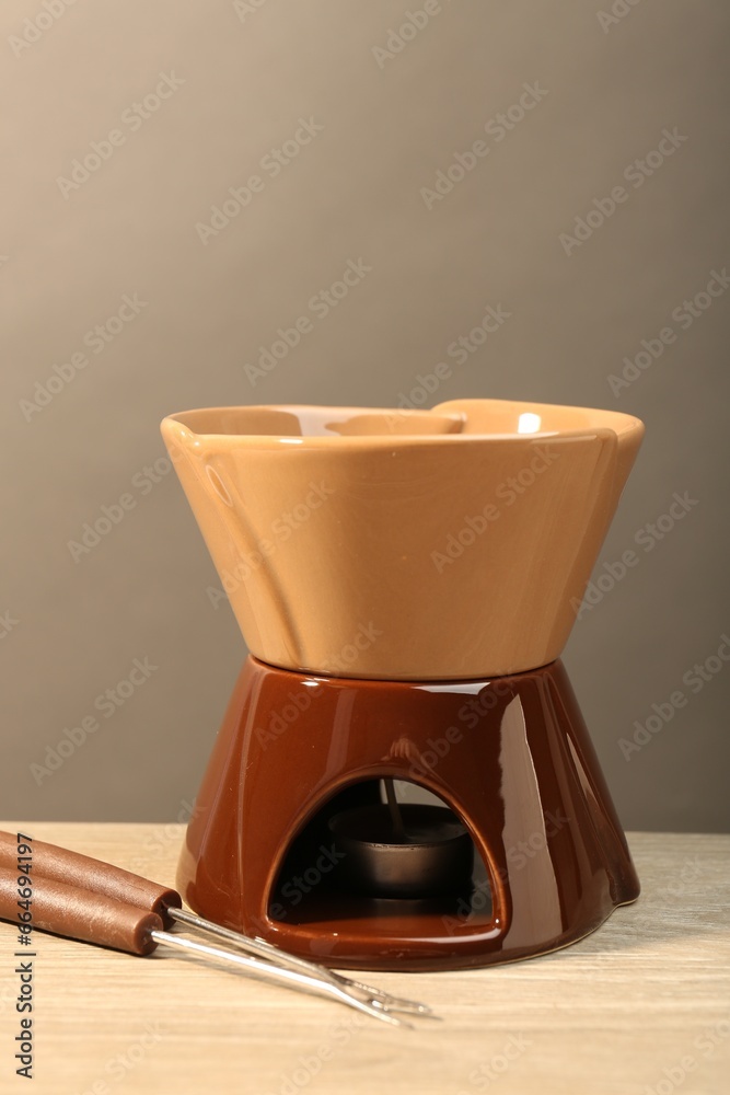 Fondue set on wooden table. Kitchen equipment Fondue set on wooden table. Kitchen equipment