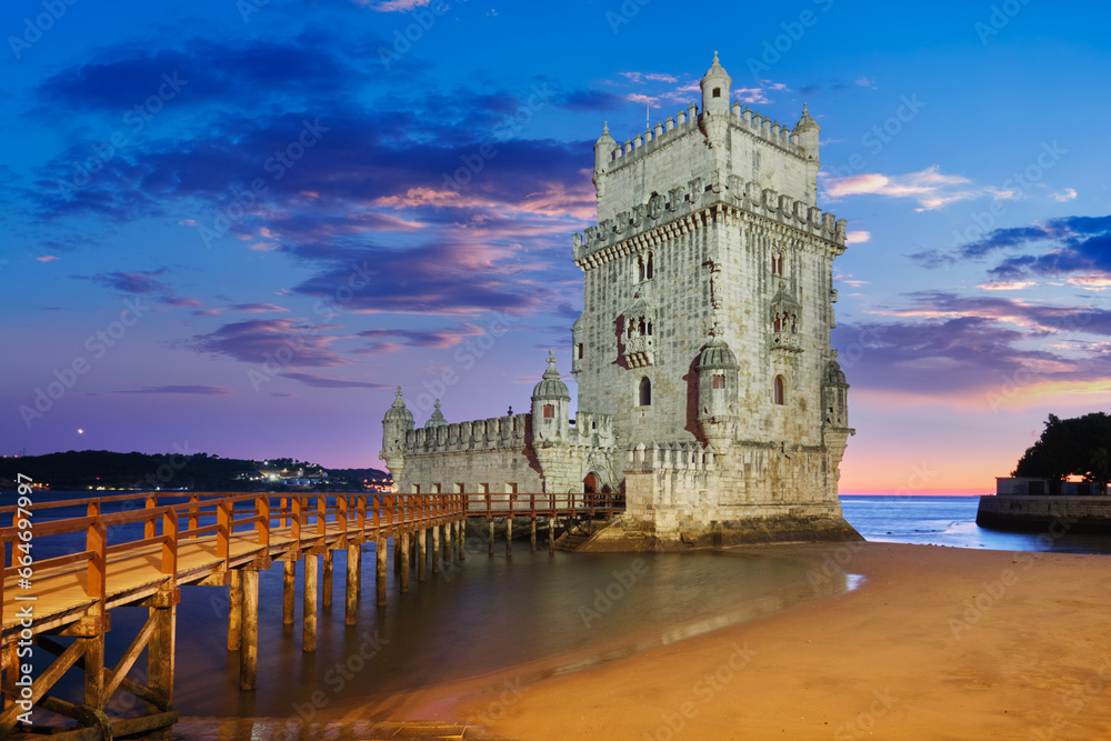 Belem Tower or Tower of St Vincent - famous tourist landmark of Lisboa and tourism attraction - on the bank of the Tagus River (Tejo) after sunset in dusk twilight with dramatic sky. Lisbon, Portugal