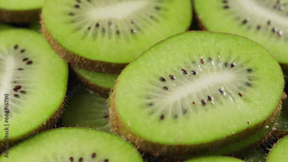 Close-up of green ripe kiwi slices, slowly rotating Close-up of green ripe kiwi slices, slowly rotating