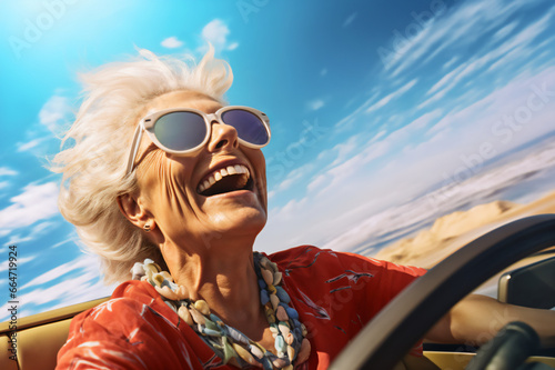 Happy old woman lady enjoying summer road trip, adventure in luxury convertible car, happy old age, lifestyle of wealth and freedom