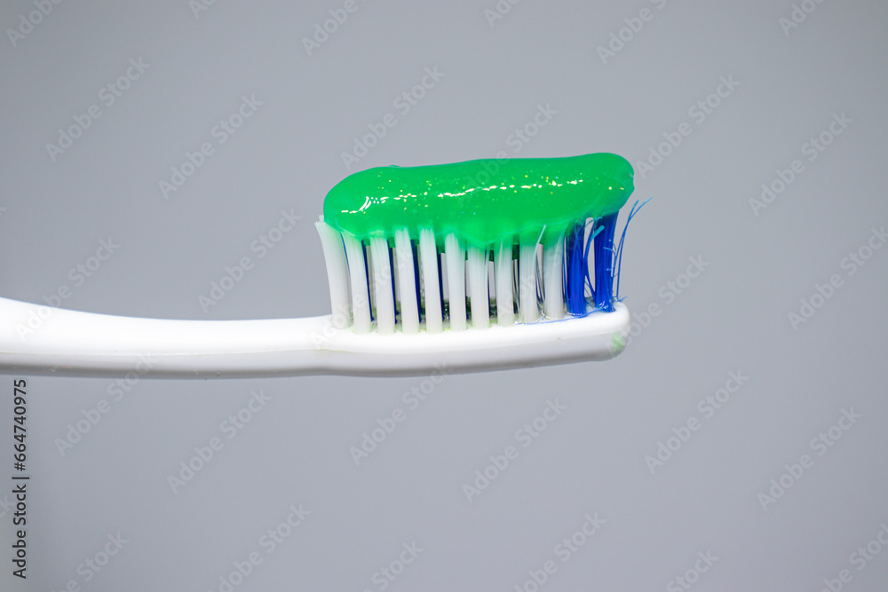 green toothpaste on a toothbrush green toothpaste on a toothbrush