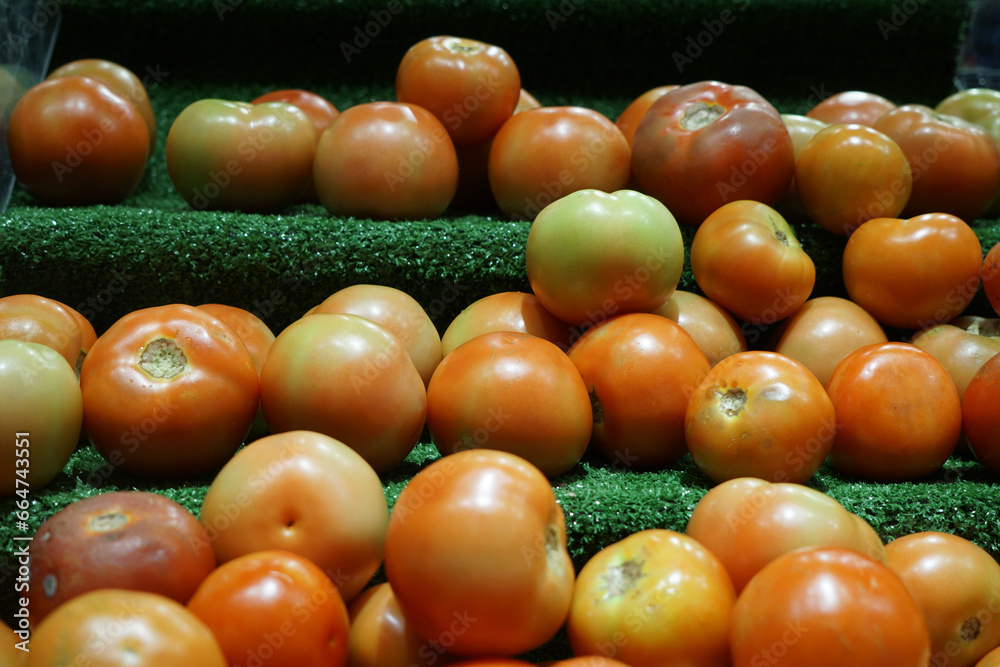 Close-up view of fresh juicy tomatoes in a supermarket. Close-up view of fresh juicy tomatoes in a supermarket.