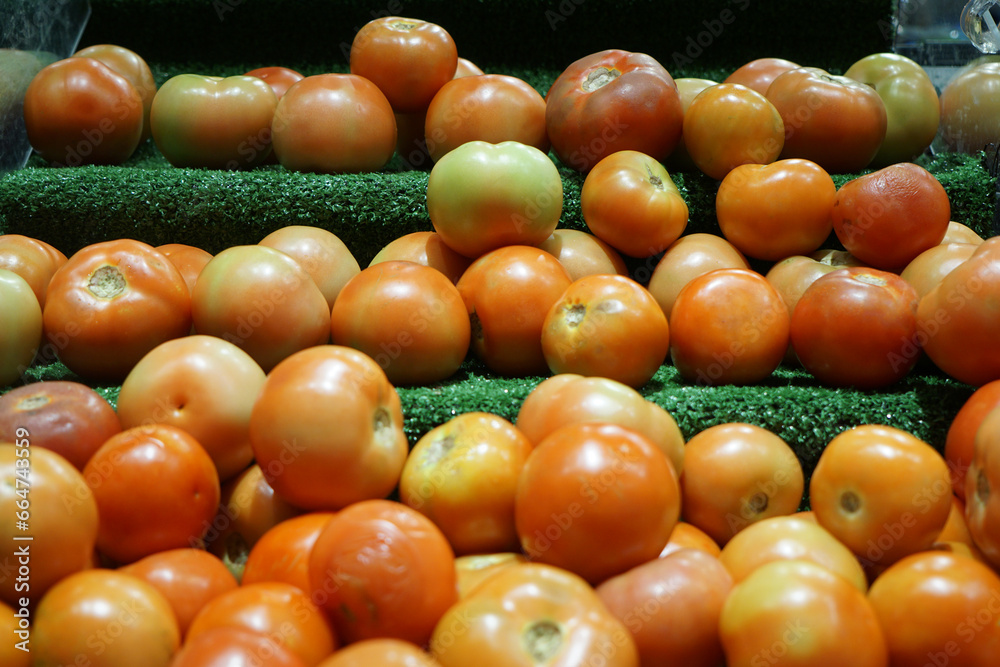 Close-up view of fresh juicy tomatoes in a supermarket.