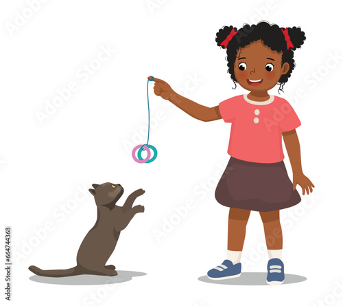 Cute little African girl pet lover playing with her cat