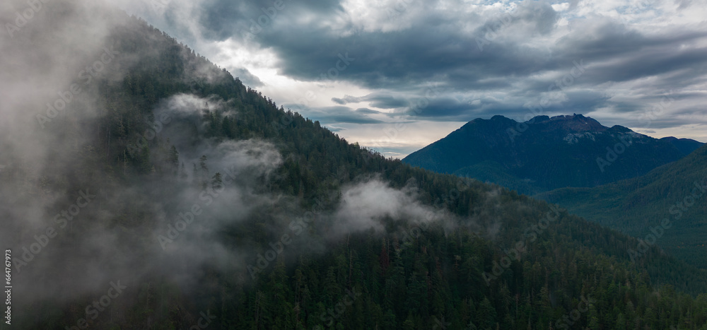 Canadian Mountain Landscape Covered in Clouds. Aerial Nature Background.