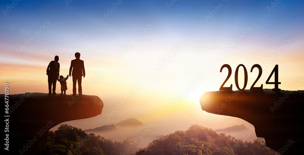 New Year 2024 and family on on the mountain at sunset background New Year 2024 and family on on the mountain at sunset background