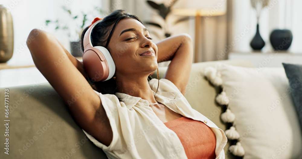 Woman, headphones and relax with music, sofa and peace with sound, smile or hearing in home living room. Girl, listening and audio streaming subscription on lounge couch, happy or radio show in house - obrazy, fototapety, plakaty 