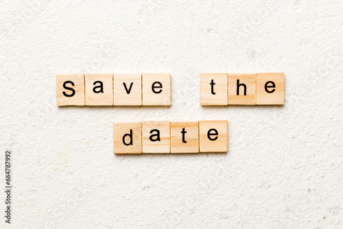 Save the Date word written on wood block. Save the Date text on table, concept