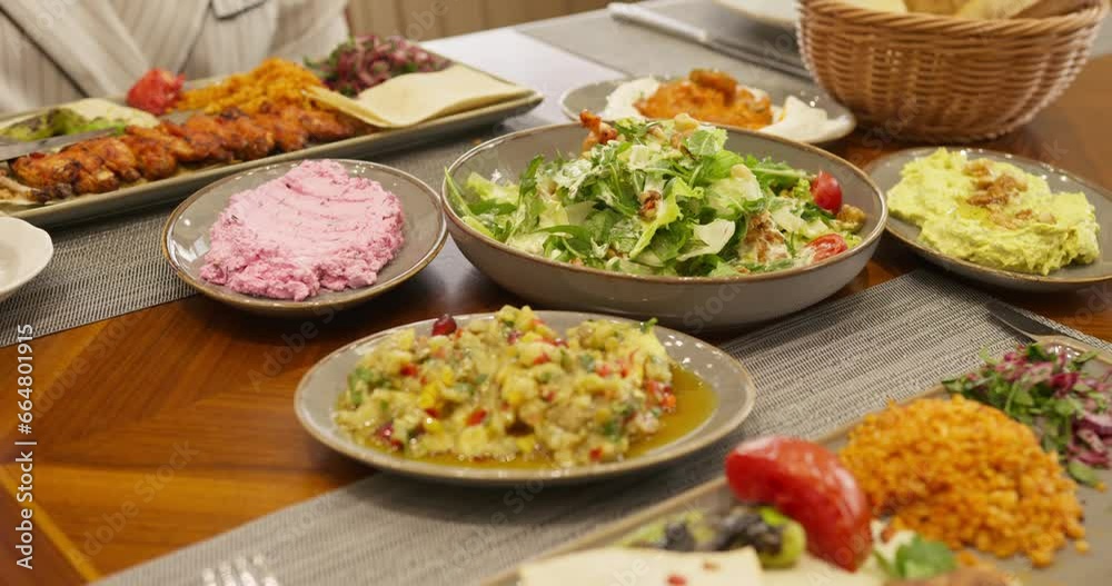 People sit at a table in a restaurant and eat People sit at a table in a restaurant and eat