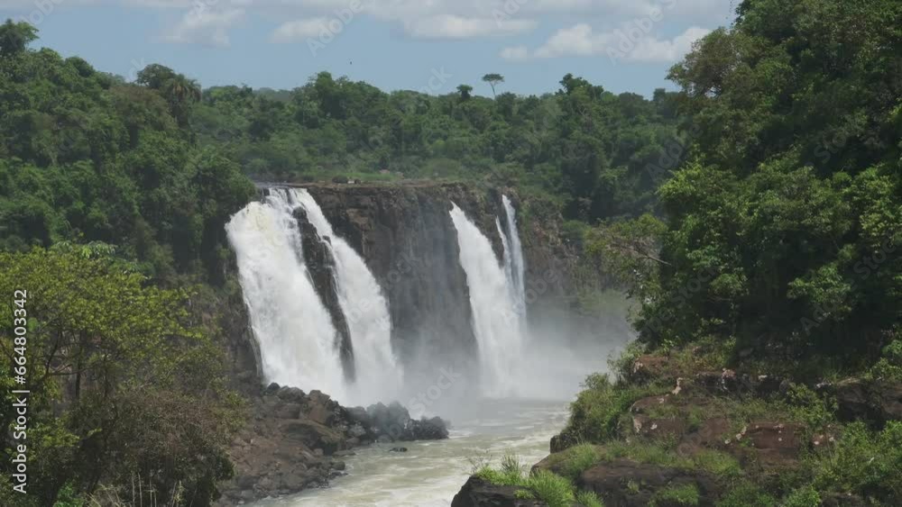 Iguazu Falls Waterfall in Brazil, Dramatic Distant View of Beautiful Waterfalls in Picturesque Jungle Greenery Landscape, Amazing Water Falling off Huge Cliffs in Beautiful Sunny Conditions Iguazu Falls Waterfall in Brazil, Dramatic Distant View of Beautiful Waterfalls in Picturesque Jungle Greenery Landscape, Amazing Water Falling off Huge Cliffs in Beautiful Sunny Conditions