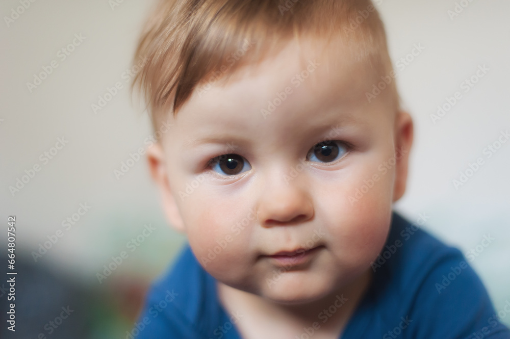 Cute baby boy looking at camera. Close-up detail front view. Love and family concept