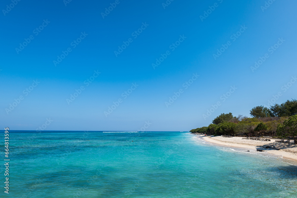 Tropical sandy beach with turquoise ocean water at Gili Trawangan, one of the Gili islands in Lombok, Indonesia