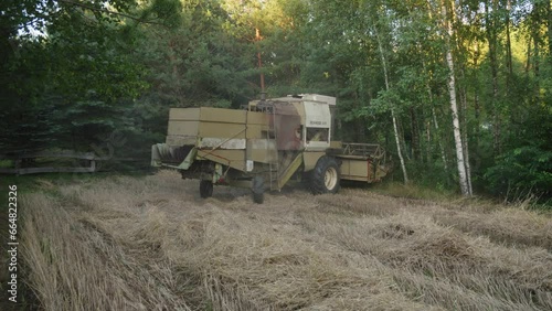 Wallpaper Mural A combine-harvester Engaged Mowing Hay in Borowy Mlyn, Poland - Wide Shot Torontodigital.ca