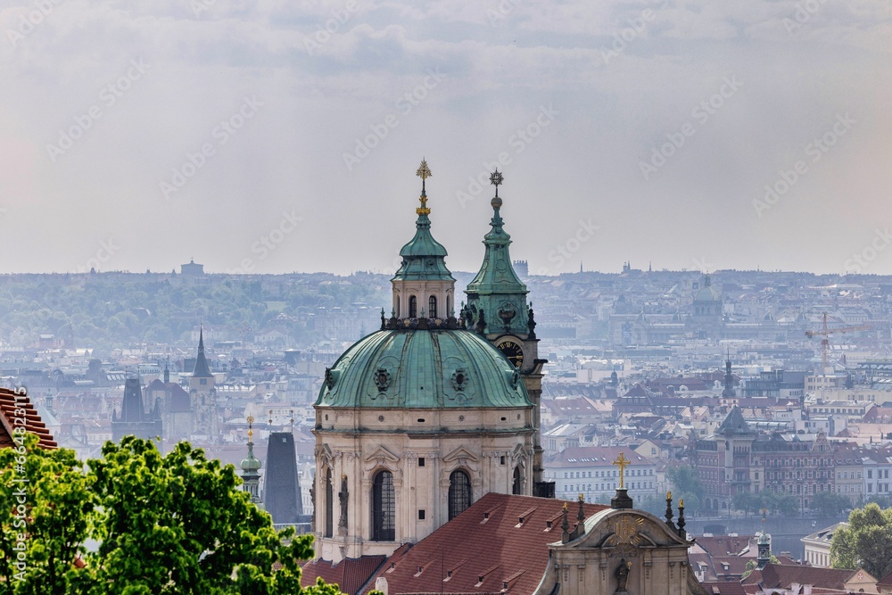 Aerial view of Church of Saint Nicholas in Prague, Czech Republic with a cityscape in the background