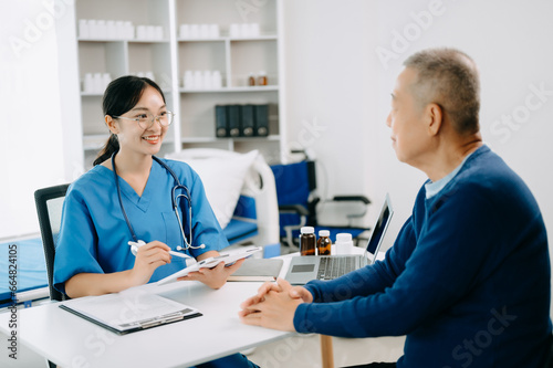 Serious Asia female doctor using clipboard is delivering great news talk discuss results or symptoms with female patient in clinic or hospital .