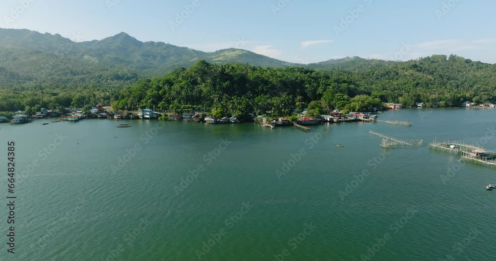 Aerial drone view of Fisherman village near the coast in Lanao del Norte. Mindanao. Philippines. Seascape. Aerial drone view of Fisherman village near the coast in Lanao del Norte. Mindanao. Philippines. Seascape.
