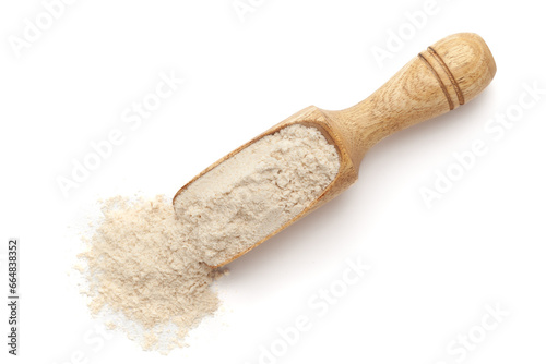 Organic Wheat Flour (Triticum) in a wooden scoop, isolated on a white background. Top view.