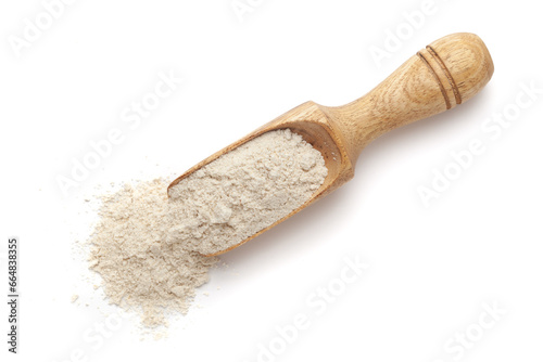Organic Sorghum Flour (Sorghum bicolor) or Jowar Flour in a wooden scoop, isolated on a white background. Top view.