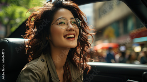 Beautiful Asian woman gets a new car She is very happy and excited. Woman driving a car smiling on the road on a bright day