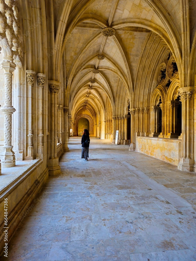 a person walks along a long corridor in the middle of a building