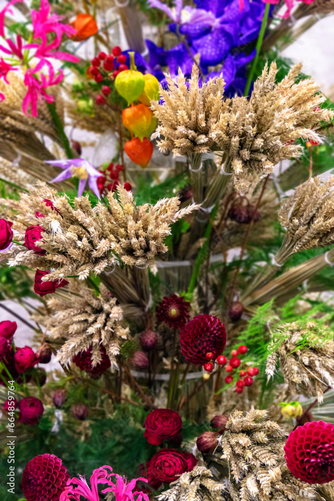 Floral arrangement of dry bunches of wheat and flowers in folk style. Floral arrangement of dry bunches of wheat and flowers in folk style.