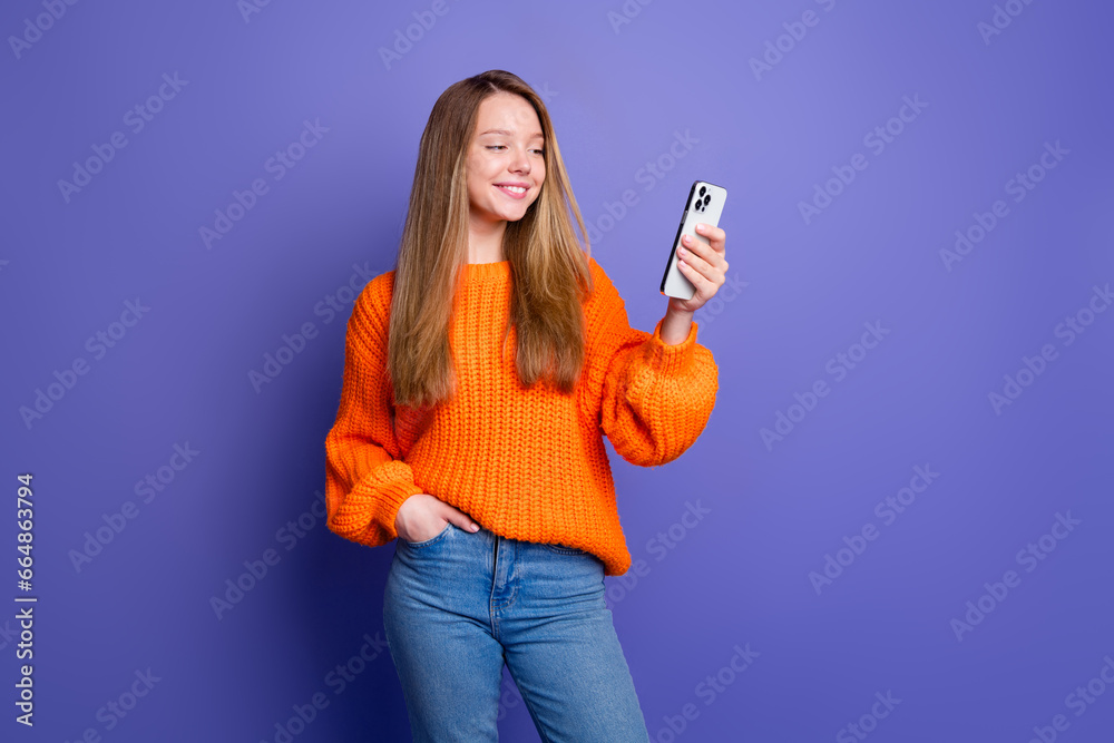 Photo of blogger young girl make purchase online click smartphone display to buy sweets for halloween isolated on purple color background Photo of blogger young girl make purchase online click smartphone display to buy sweets for halloween isolated on purple color background