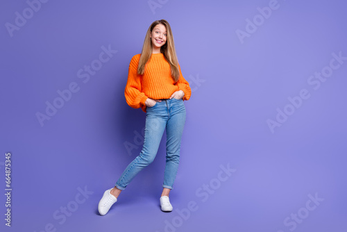 Full body portrait of adorable lovely girl put arms pockets empty space ad blank isolated on purple color background