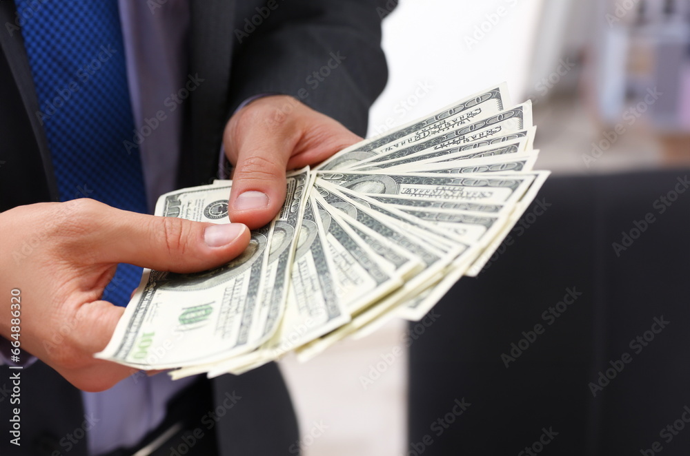 © H_Ko - Man in suit and tie hold in arm pack of hundred dollar bills closeup. Stock market exchange earn pile rich present gift employer prepayment service gratitude concept © H_Ko - Man in suit and tie hold in arm pack of hundred dollar bills closeup. Stock market exchange earn pile rich present gift employer prepayment service gratitude concept