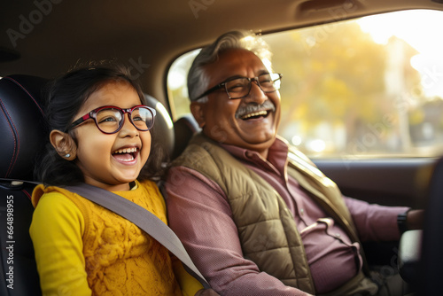 indian grandfather and granddaughter driving car