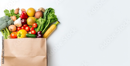 Healthy food in paper bag vegetables and fruits on white background. © Md