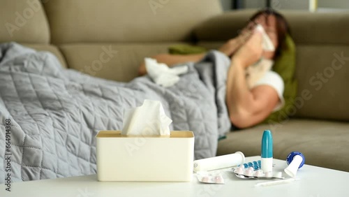 Medicine, sick and woman on the sofa with pills for an allergy, virus or cold.