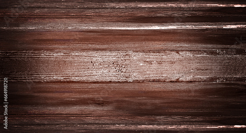 The dark brown wooden background