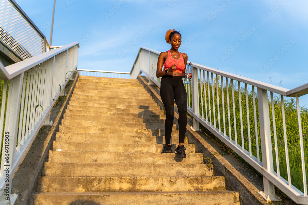 The African American girl's determination fuels her as she conquers the staircase, transforming it into a dynamic and energizing component of her fitness regimen.