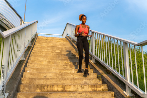 The African American girl's determination fuels her as she conquers the staircase, transforming it into a dynamic and energizing component of her fitness regimen.