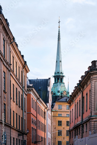 Colourful buildings of the  Old Town Gamla Stan with Bell Tower of a Church photo
