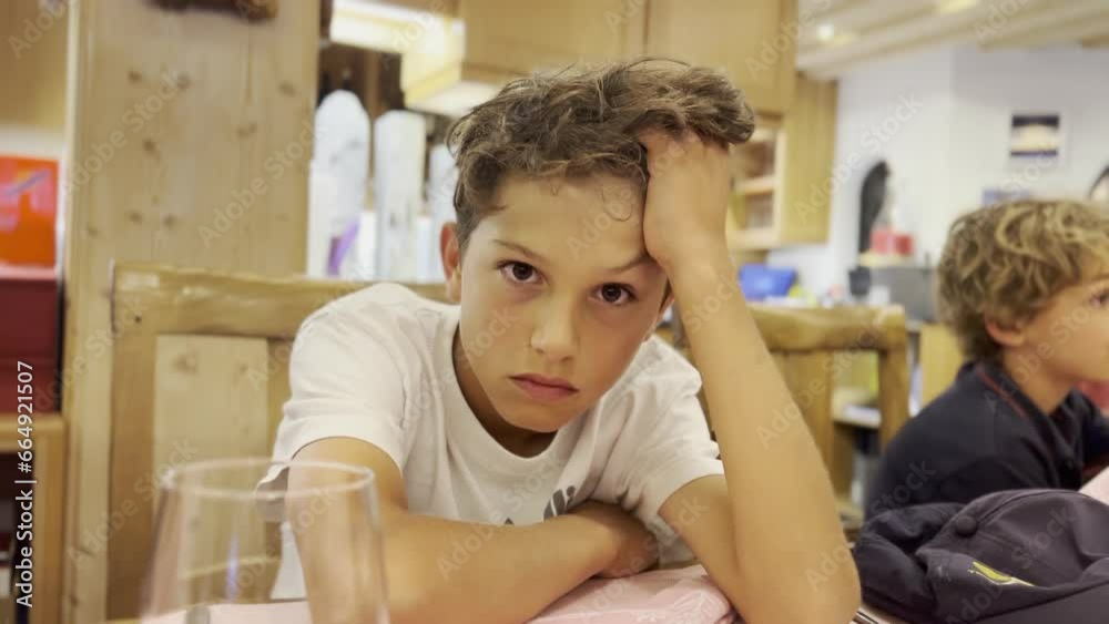 Bored Teen Boy During Family Dinner - Elbows on Table and Hand on Forehead Bored Teen Boy During Family Dinner - Elbows on Table and Hand on Forehead