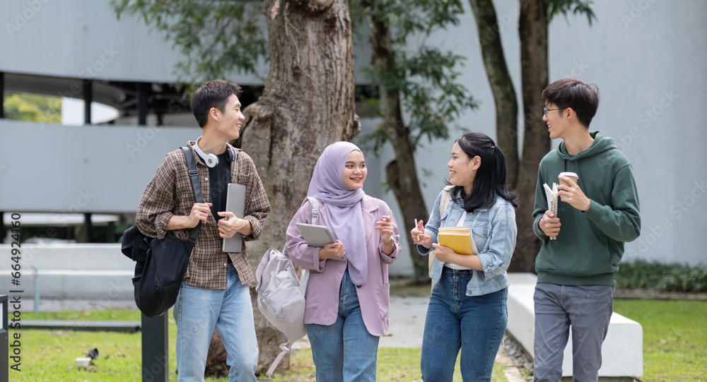 Fototapeta premium Student friendship concept with multiracial diverse classmate friend sitting together at campus college park. Millennial people having fun social gathering outside. Youth teenage and education