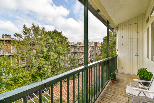 a balcony with trees and buildings in the background on a sunny day, taken from an apartment's balcony