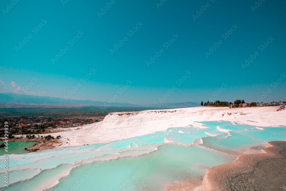 Pamukkale contains hot springs and travertines, terraces of carbonate minerals left by the flowing water.