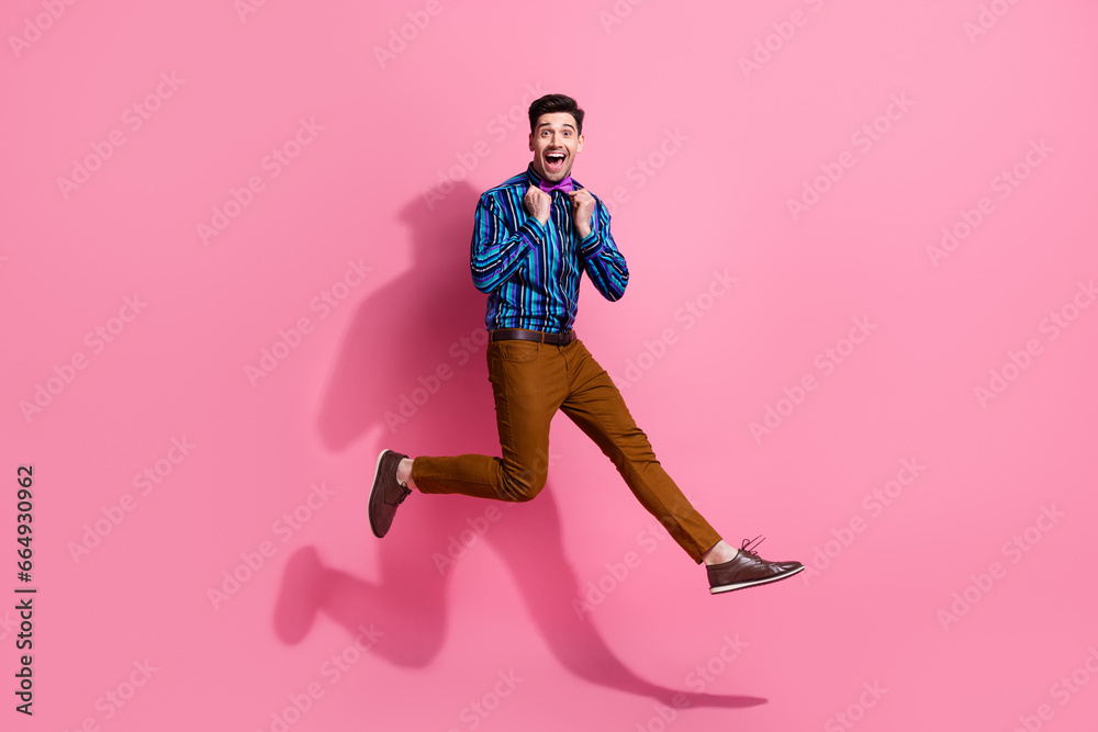 Full body length photo of jumping happy guy touch his bow dress stylish vintage outfit classy clothing isolated on pink color background
