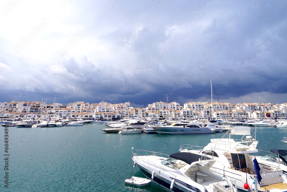 dark clouds over luxury yachts in Puerto Banús marina near Marbella, Málaga, Andalusia, Spain